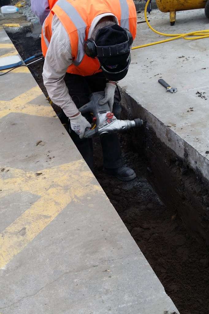 The trench is dug to approx 150mm below the channel depth (200mm wide drain) taking into account the built-in-fall. Holes are drilled for the rebar stirrups 